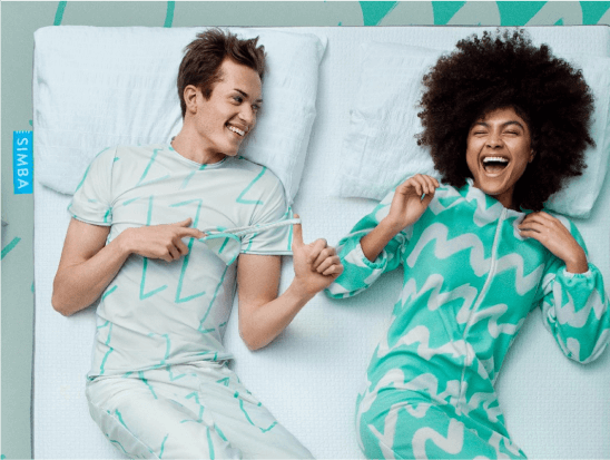 Two people lying on a Simba Sleep mattress